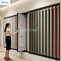 Modern metal display rack for showcasing flip-style art-painted mosaic tiles in a floor showroom